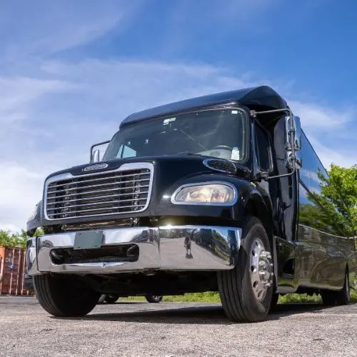 Exterior of a luxury black party bus for rent in Orlando under a clear blue sky